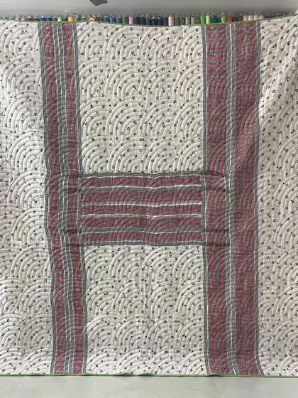 The alternate side of the checked saree quilt, featuring a different pattern and color scheme.