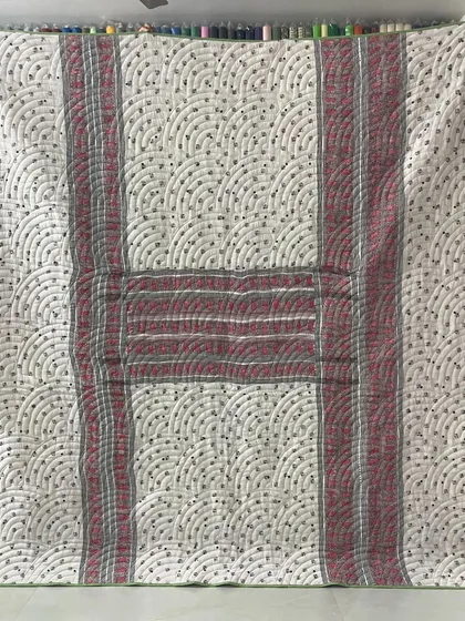 The alternate side of the checked saree quilt, featuring a different pattern and color scheme.