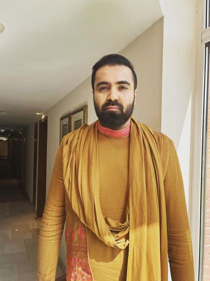 A simple yet elegant look for a pre-wedding ceremony. The groom is wearing a mustard-colored kurta with a draped stole, and I provided natural grooming to keep his look fresh.