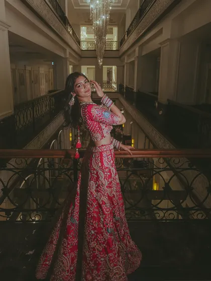 A stylish portrait of the bride on a balcony, using the architectural lines of the hotel to create a strong composition.