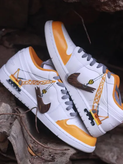 A top-down view of the "Under Construction" Air Jordan 1s, showing how the design wraps around the entire shoe. I used high-quality Angelus paints to ensure the artwork is durable.