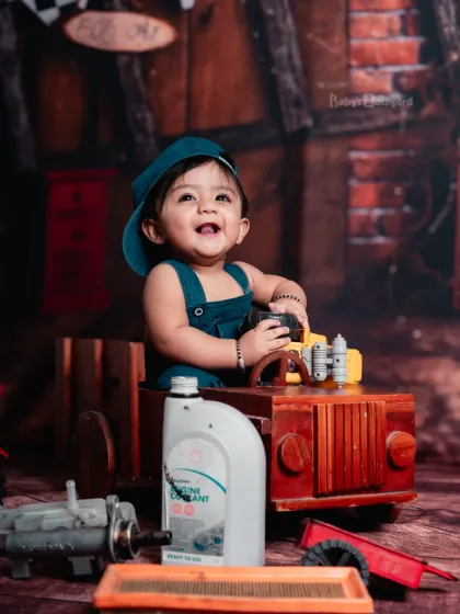 Grease and giggles, the cutest mechanic in town. Our garage setup is perfect for little ones who love cars and tools.