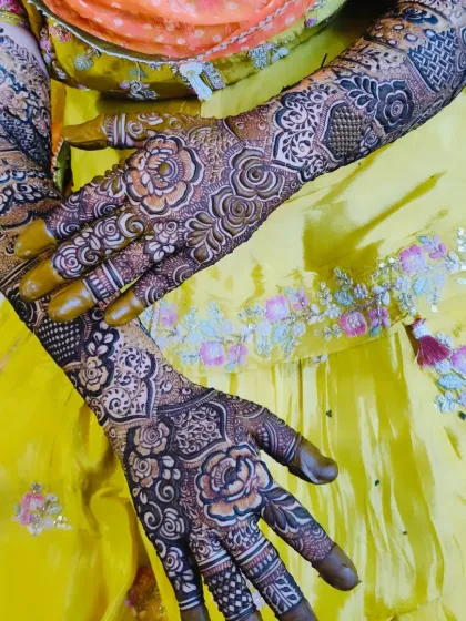 A stunning bridal design with full coverage, featuring the name 'Faraz' on the palm. The rich color and detail are perfect for a bride.