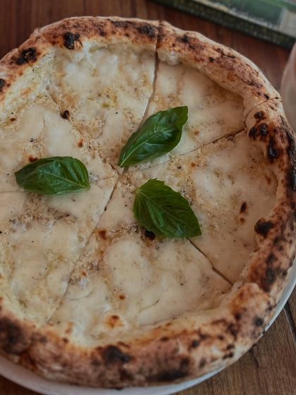 Another angle of our Bianca pizza, showing off its cheesy goodness.