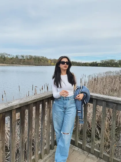 A full-length shot of a casual, cool-toned outfit against the backdrop of Heart Lake, ON.