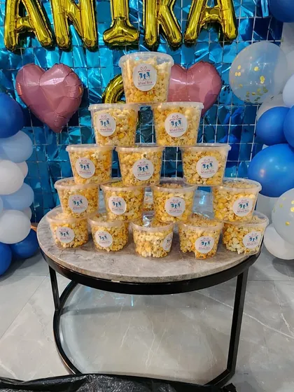 Our popcorn tubs displayed as part of the birthday decor. They are a great addition to any dessert table or favor station.