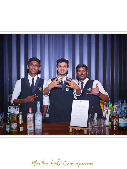 Three of our bartenders bringing their unique style and energy to an event. This image highlights the personality and flair that our team members add to the bar experience.