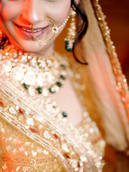 A close-up of the bride's smile and her stunning jewelry.