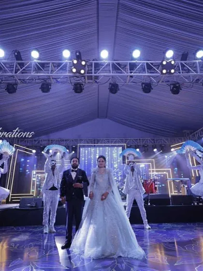 A perfectly symmetrical and choreographed welcome for the couple's sangeet. The performers create a beautiful tableau, making for a stunning photo opportunity and a grand start to the party.