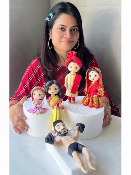 Me with some of my favorite handcrafted fondant figurines. This is my passion, and I pour my heart into every creation.
