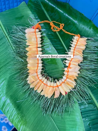 A traditional 'Chafa Kanthi' made from fragrant plumeria flowers. This type of garland is deeply rooted in Maharashtrian culture and is often used for worship.