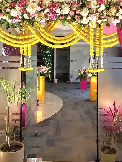 The entrance to one of the office sections, framed with marigold garlands and bright pink drapes. This created a grand and festive feel for the company's Diwali party.