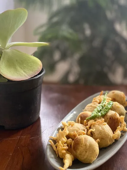 A plate of hot, crispy Mini Vadas, a perfect savory snack, especially during the monsoon. I serve them with fried green chilies, just the way they are enjoyed back home.