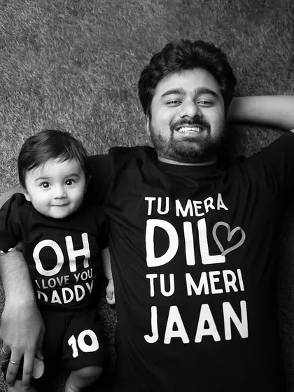 The same father-son portrait in timeless black and white, emphasizing the emotion and connection.
