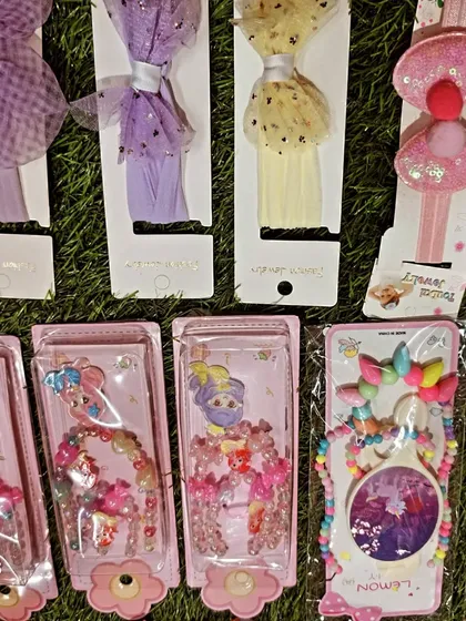 This image highlights some of my glittery and tulle hair accessories. You can see different headbands and beaded jewelry sets that are perfect for a princess or fairy themed party.