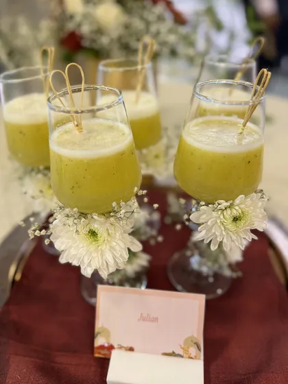 A tray of our 'Julian' mocktails, each glass decorated with a fresh flower. This is an example of our creative and elegant beverage presentation.