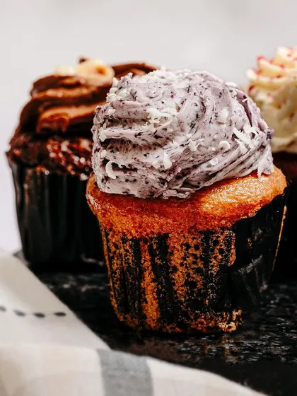 Food photography is about creating desire. This close-up of a cupcake focuses on the rich texture of the frosting and the moist cake, making the product look irresistible and delicious.