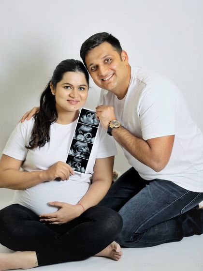 Another take on the sonogram announcement, this time with a casual, relaxed vibe. The couple is dressed in simple t-shirts and jeans, creating a natural and approachable portrait.
