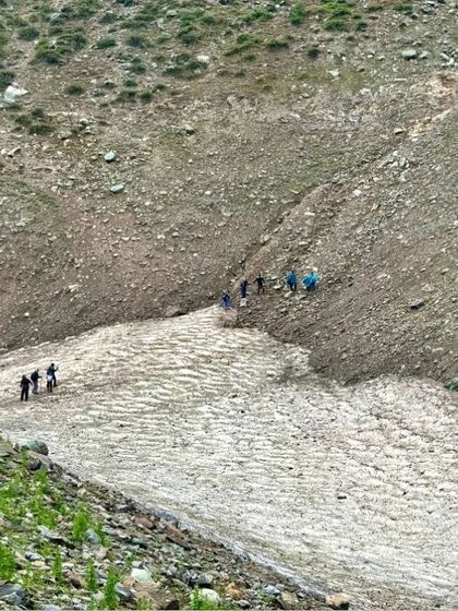 Crossing a patch of snow on the trail. The varied terrain of the Kashmir Great Lakes trek keeps the journey exciting and offers new landscapes to explore each day.