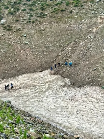 Crossing a patch of snow on the trail. The varied terrain of the Kashmir Great Lakes trek keeps the journey exciting and offers new landscapes to explore each day.