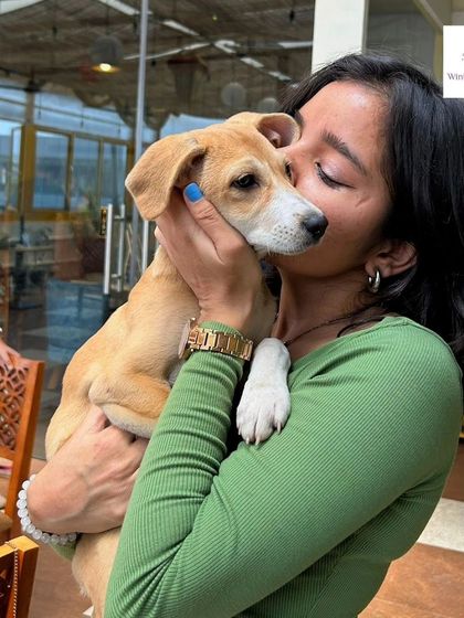 Puppy love and pottery. A participant shares a sweet moment with an adoptable puppy during our special "Paws & Pottery" event, combining creativity with a cause we love.