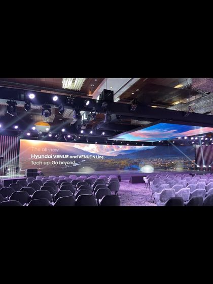 An empty conference hall before the Hyundai Venue launch, showing the scale of the event we are about to run.