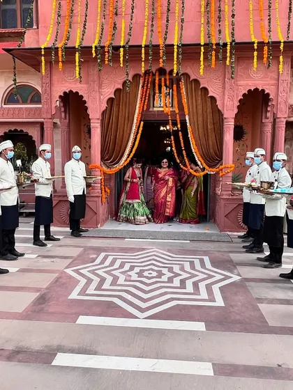 A grand welcome for the couple is where our hospitality begins. Our professional staff, in elegant uniforms, line the entrance of a beautiful palace venue, ready to serve and create a memorable start to the celebration.