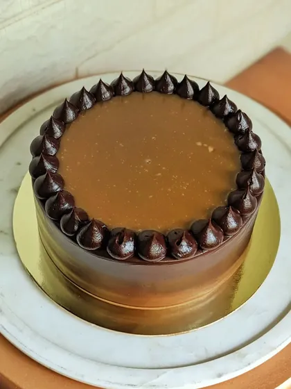A decadent chocolate cake with a glossy salted caramel drip. It's a simple, elegant, and absolutely irresistible treat.
