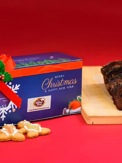 Our 'Joy' Christmas hamper, featuring a larger plum cake and ginger cookies in a festive tin box.
