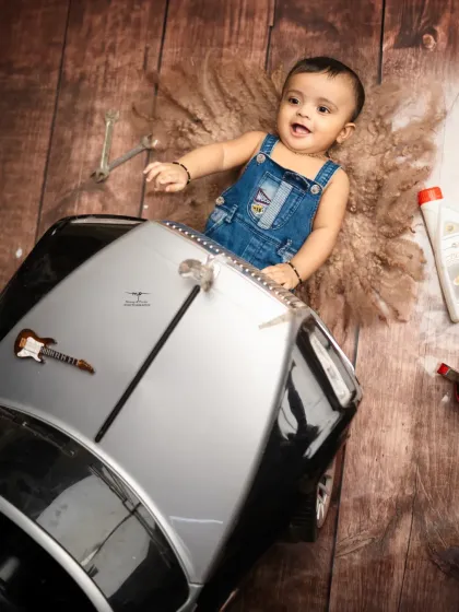 This little mechanic is ready to get to work. The rustic, industrial feel of the garage theme provides a fantastic and original backdrop for a baby boy's shoot.