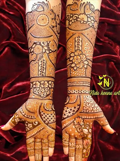 This Indian bridal design features a unique flow and structure. The patterns curve gracefully across the hands and arms, creating a dynamic and modern feel within a traditional framework.