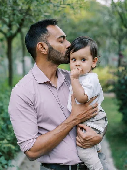 A father's gentle kiss on his son's forehead. These quiet, loving moments are what family photography is all about.