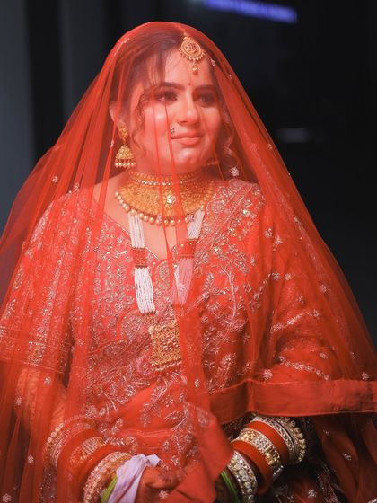 A close-up through the veil, capturing the bride's gentle expression.