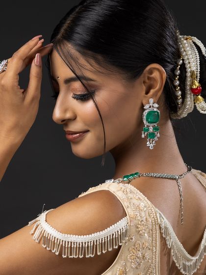 A shot from the back, showing the details of the lehenga blouse and jewellery.