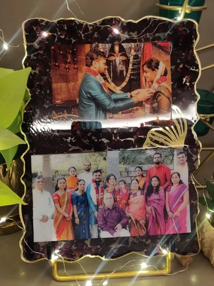 For this custom resin frame, I used the couple's varmala flowers to create a rich, dark border around their favorite wedding and family photos. The added fairy lights make it glow.