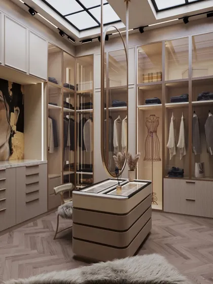 This walk-in wardrobe is all about quiet luxury, designed in soft beige tones. The central island, topped with a display case, and the faux skylight make the space feel warm and expansive.