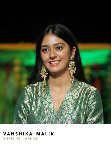 A portrait of Vanshika Malik, looking elegant and festive. The statement earrings add a touch of drama and sophistication, elevating her entire look for the wedding celebration.