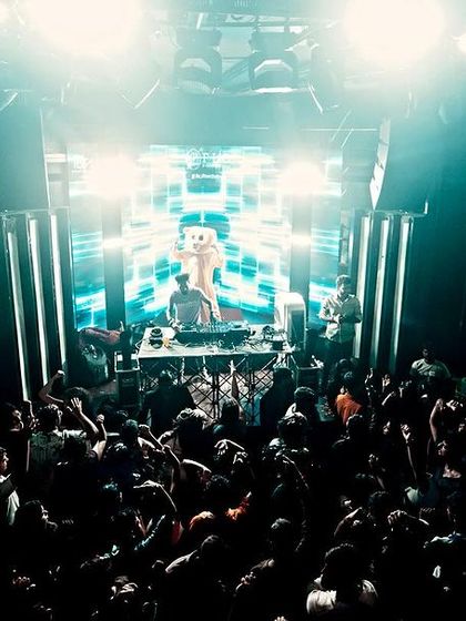 A wide shot of the club, showing a full house under cool teal lighting. This is the kind of turnout I love to see.