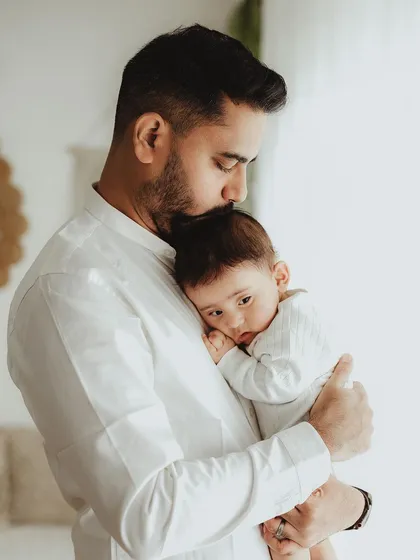 A father's gentle embrace. We focus on the quiet, strong bond between a dad and his baby, creating powerful and emotional portraits.