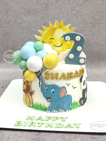 A "Love for animals" cake featuring a happy sun, an elephant holding balloons, a lion, and a panda.