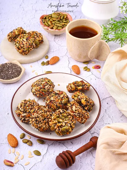 The same healthy bites, this time styled with a cup of tea. This creates a more relaxed, "teatime snack" vibe, showing the product's versatility.