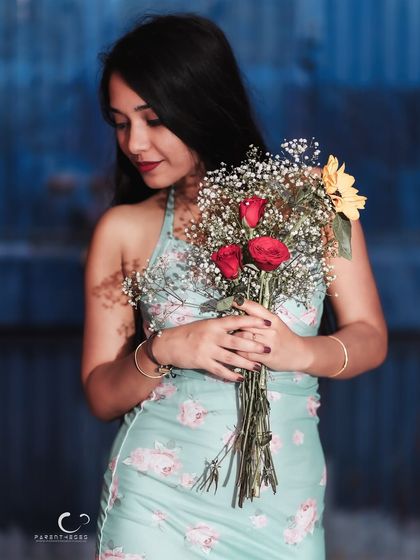 A sweet and gentle moment, looking down at the flowers. This portrait is full of warmth and a quiet, romantic charm.