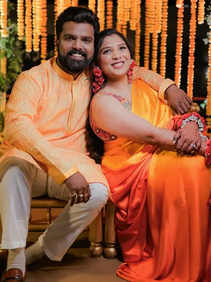 A classic couple portrait from the Haldi, capturing their smiles and coordinated outfits.