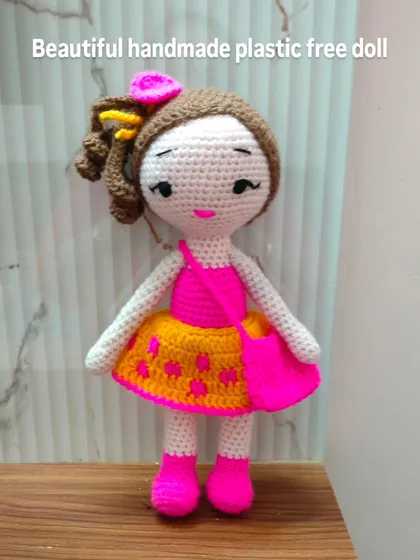 This doll is dressed in bright pink and yellow. All my dolls are plastic free and safe for kids.