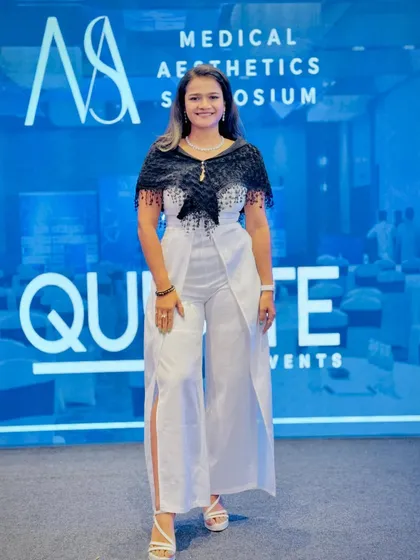 My look for Day 2 of the Medical Aesthetics Symposium, a chic and professional white jumpsuit with a stylish black shawl.