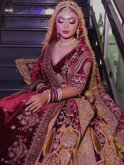 A seated pose showing the beautiful drape of the velvet fabric and the detailed craftsmanship of this bridal attire.