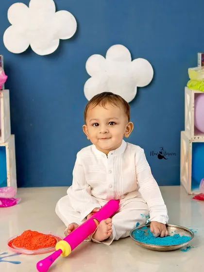 This little boy is ready to celebrate, holding his pichkari and sitting amongst bowls of bright colors. A perfect setup for a memorable Holi shoot.