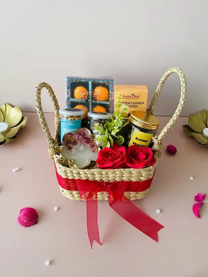 My eco-friendly Kauna square basket, filled with laddoo candles, gourmet snacks, and a resin T-light holder. A stylish and sustainable gift.