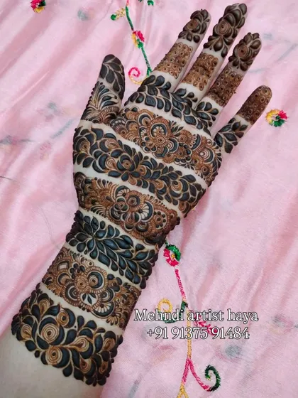 This unique design features horizontal bands of intricate patterns, a modern take on traditional Indian motifs. The use of negative space makes each band stand out.