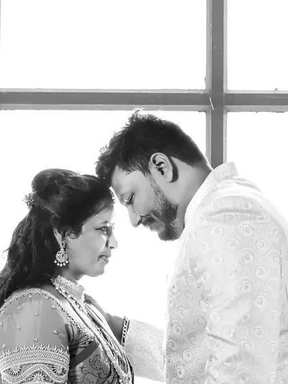 Sometimes, the most powerful portraits are the simplest. This black and white shot of a couple uses high-contrast window light to create a timeless and intimate moment, focusing purely on their connection.
